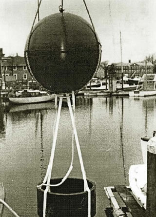 Prototype SOFAR float in Woods Hole in the late 1960s. (Photo courtesy of Tom Rossby). The sphere housing the electronics and battery has a diameter of 1m, with the transducer hanging below. See Rossby & Webb 1970.